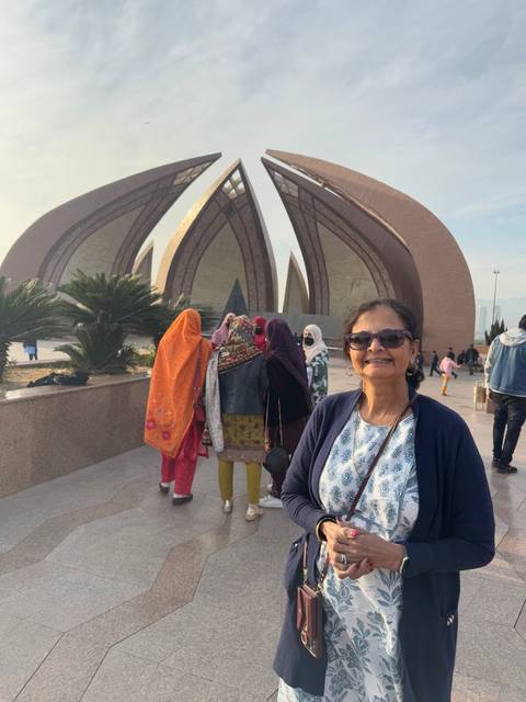 People in front of a monument with a unique architectural design.