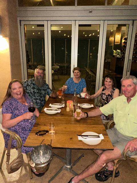 Group of people dining at a table in a restaurant.