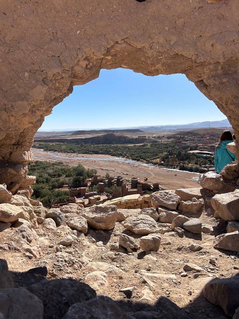 View of the landscape through a stone archway.