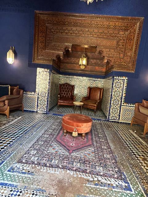 Elegant room with ornate decor and patterns on the walls and furniture.