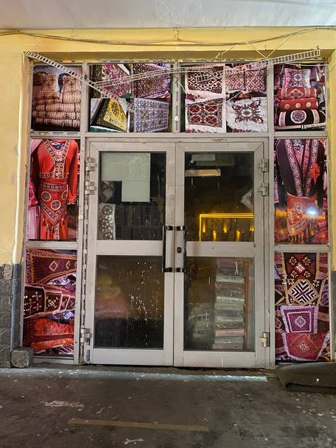 Colorful fabric store display with glass windows and shelves.