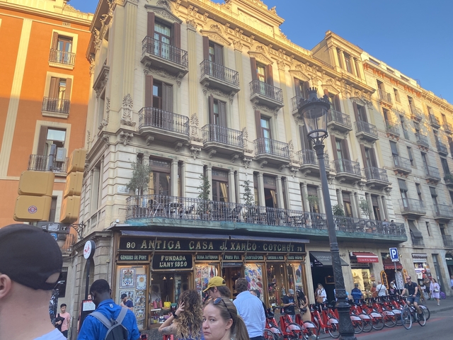 Historic building with balconies and storefronts.