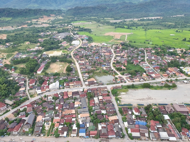 Aerial view of a small town with surrounding greenery.
