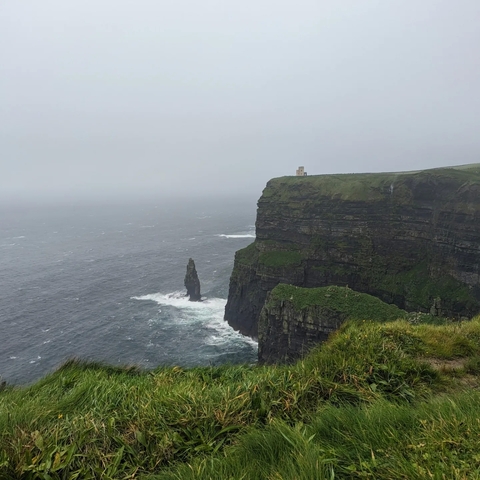Iconic tall cliffs meeting rough sea waters.