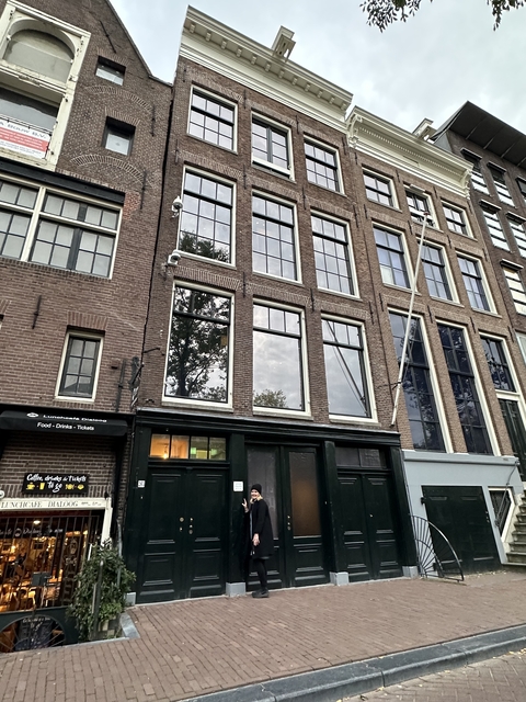       A building with brick facade, possibly in a European city.
  