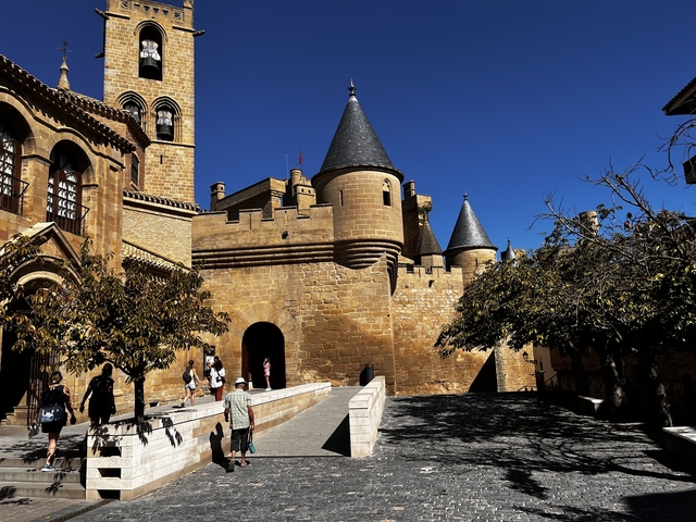 A grand castle with conical towers under a blue sky.