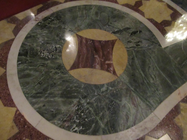       Close-up of a green and yellow tiled floor.
  