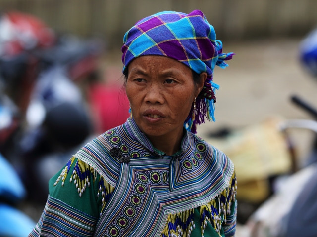 Portrait of a woman with a colorful headdress.