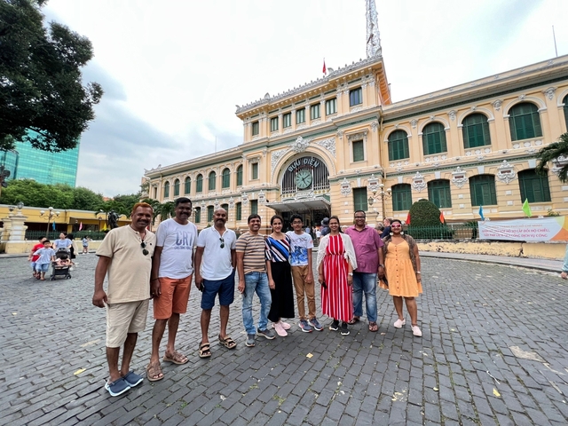       Group posing in front of a historic post office building
  