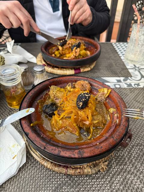 Plated Moroccan dish with meat and prunes.
