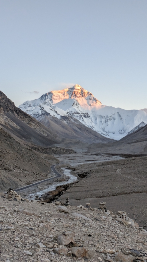       Distant view of snowcapped mountains with cloudy sky.
  