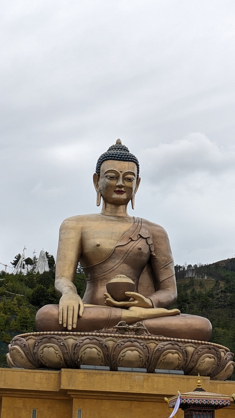       Large golden Buddha statue.
  