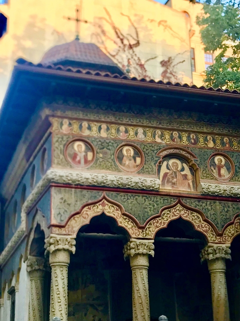 Detail of painted religious frescoes on a building.