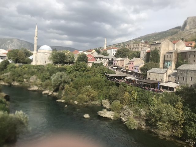 Scenic view of the Old Bridge in Mostar with surrounding buildings.