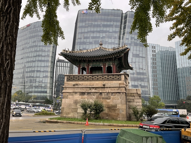       Traditional Korean structure in modern urban landscape.
  