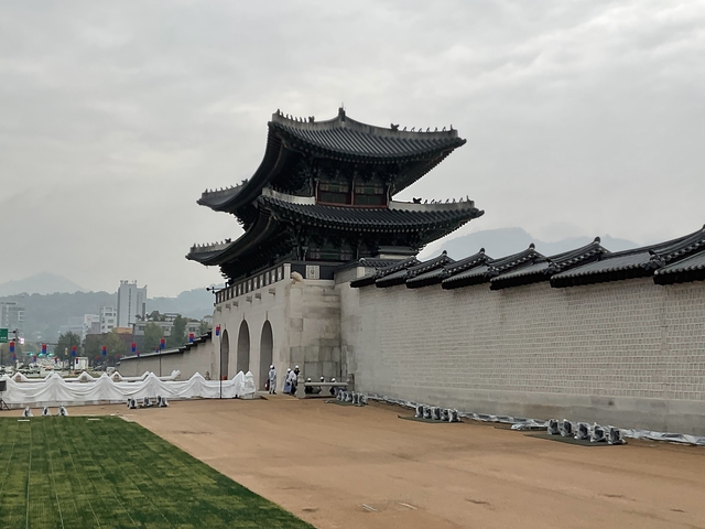       Mountain fortress with city backdrop.
  