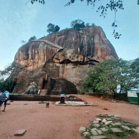 Rocky cliff with a staircase leading to the top.