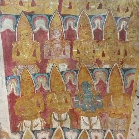       Colorful wall painting with religious figures in a temple.
  