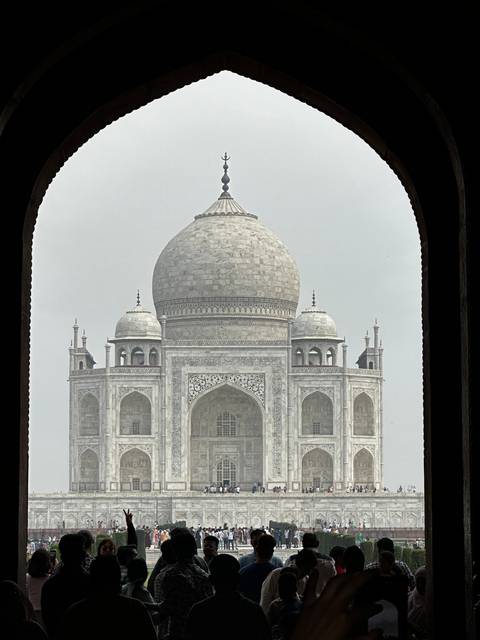 The Taj Mahal with a crowd of people.