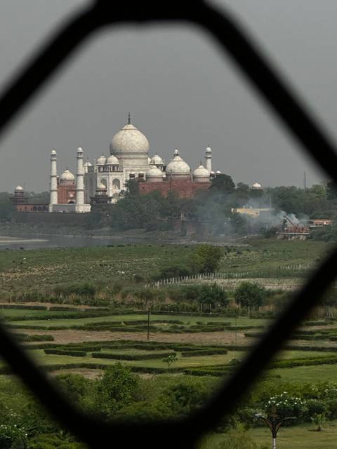 A view of the Taj Mahal framed by a window.