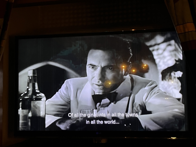 Old movie playing on a screen.