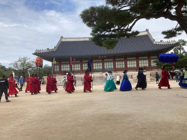 A traditional Korean parade with people in historical attire.