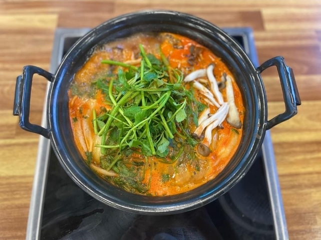 Korean dish with vegetables and broth in a pot.