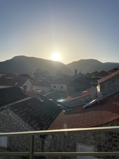       Looking over rooftops at a scenic sunset.
  