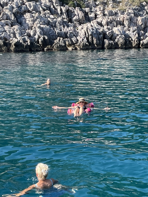       People swimming and relaxing in the sea.
  