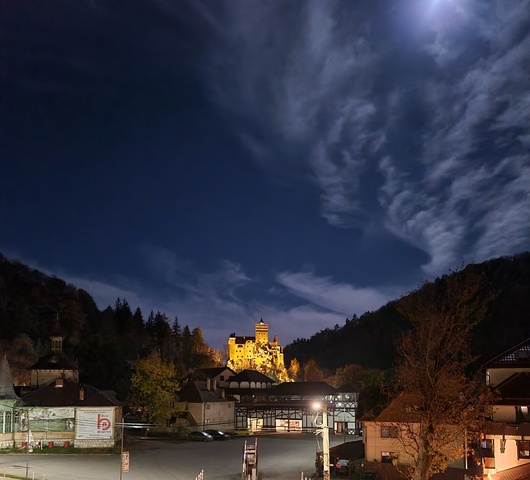 Castle illuminated against a dramatic night sky.
