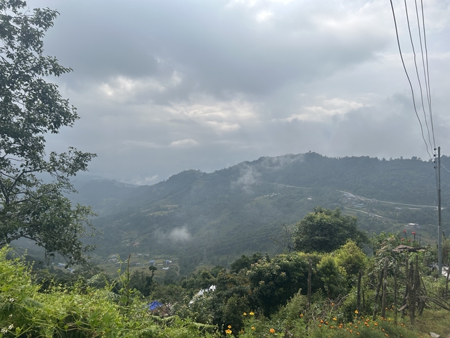 View of hilly landscape with cloudy sky.