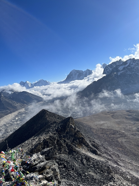 Snow-covered mountain peaks above clouds.