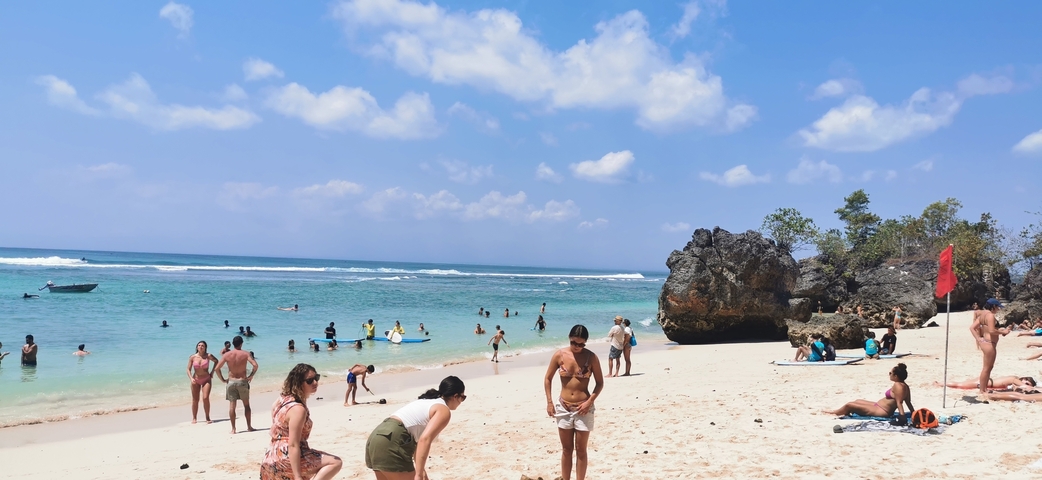 Beach with people enjoying the water and sand.