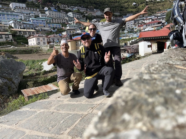Group of people posing in front of shops in Namche Bazar.