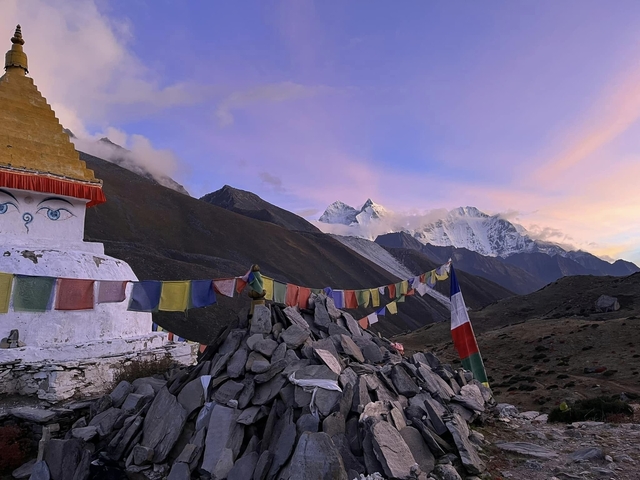 Mountain peaks at sunset with a stupa.