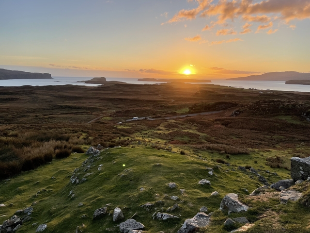       Sunset over a vast rural landscape.
  