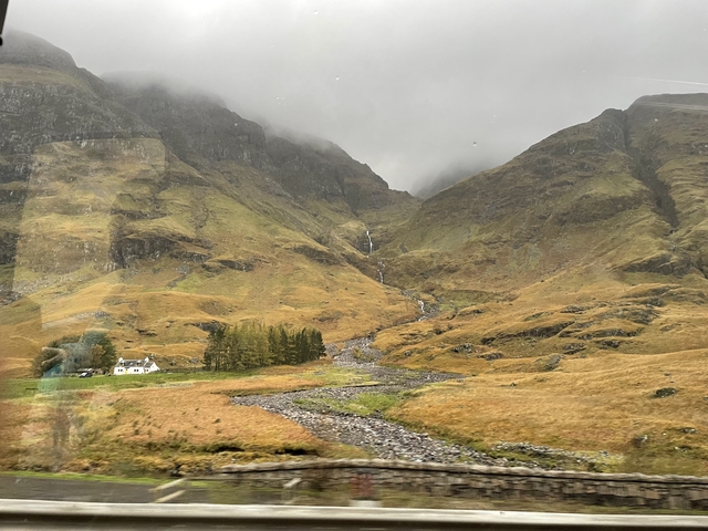       Valley with mountains in the mist.
  