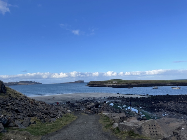       Seaside view with rocky shores and small islands.
  