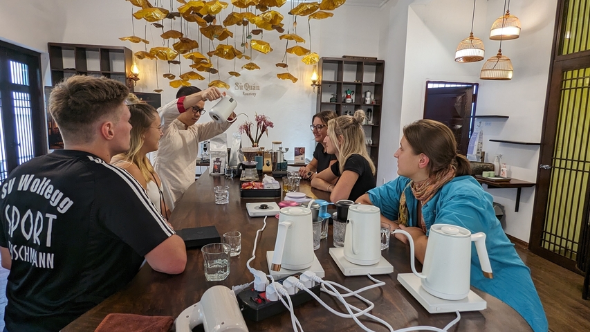 Group of people participating in a coffee brewing session.