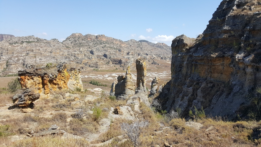       Rocky landscape with eroded formations in a dry, sunny setting.
  