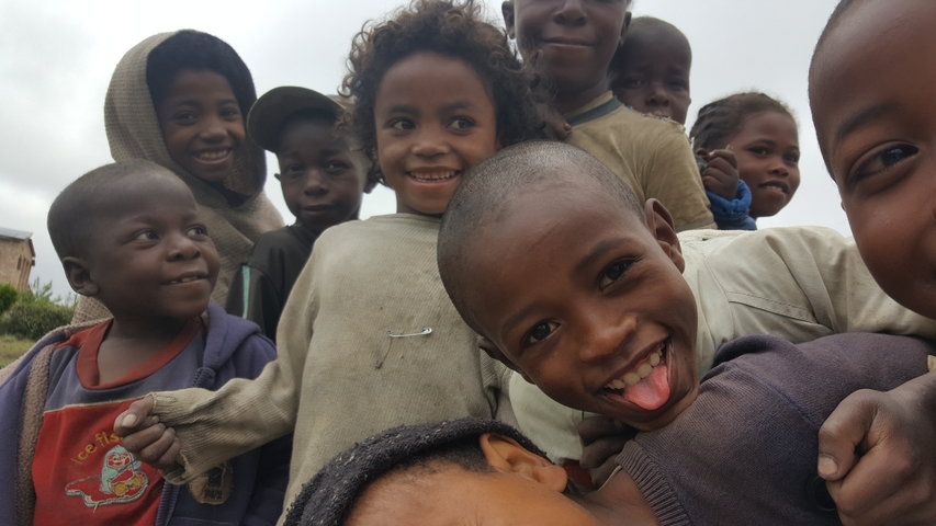       Group of smiling children posing for the camera.
  