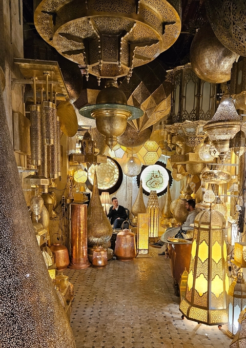 Interior shop with ornate metal lanterns and decorations.