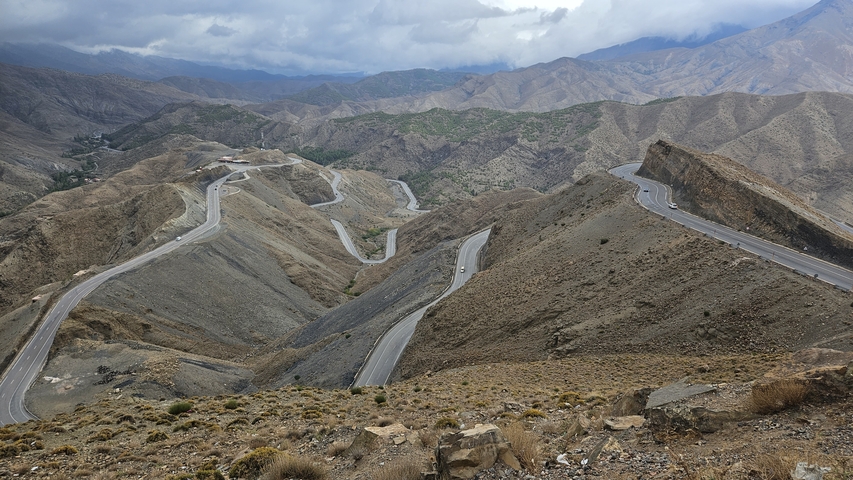       Mountain road with winding paths and dramatic landscape.
  