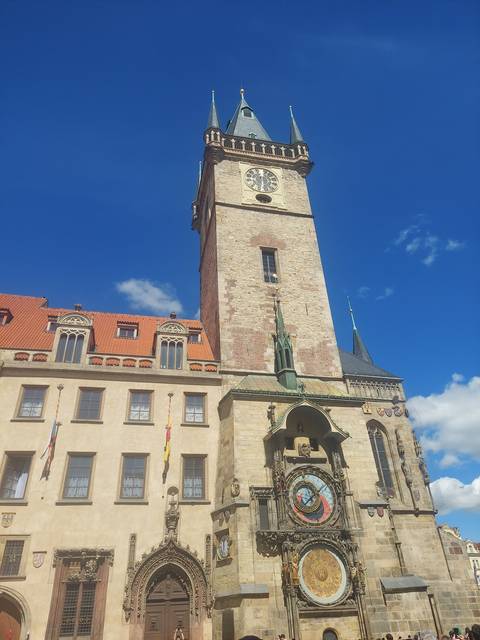 A tall clock tower with a large clock face and architectural details.
