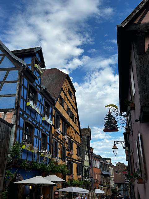 Traditional wooden houses painted in bright colors under a blue sky.