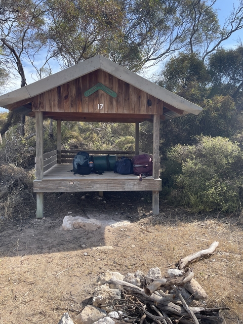       Sheltered camping site with backpacks
  