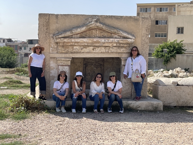       Group in front of ancient stone structure
  
