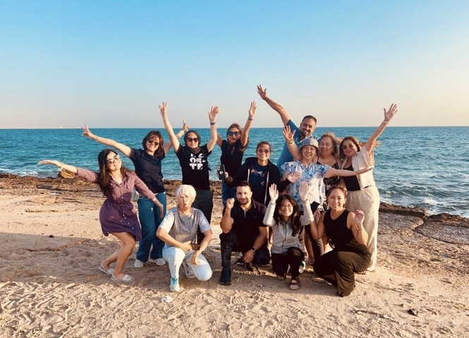 Group by the sea posing playfully