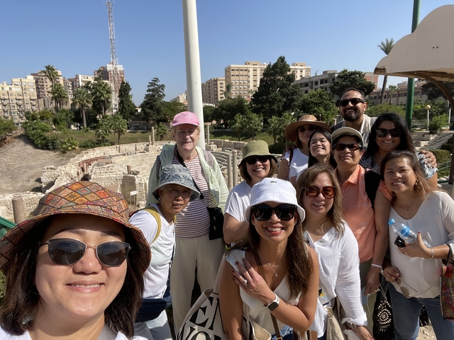       Large group in front of Roman amphitheater ruins
  
