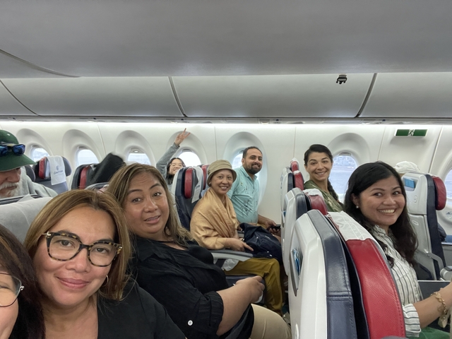       Group of people sitting inside an airplane
  